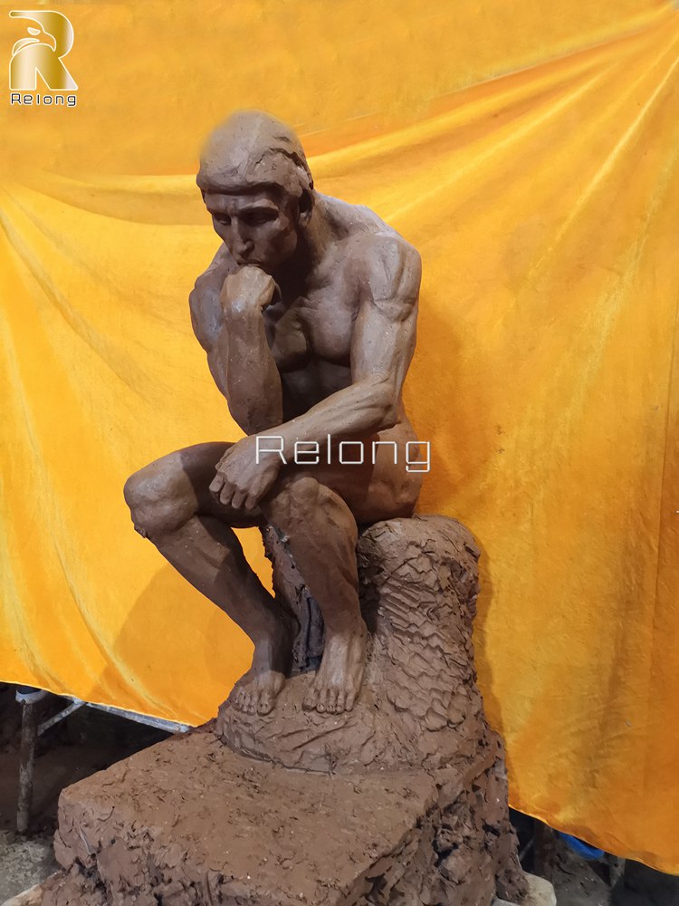 clay model of bronze thinker man statue