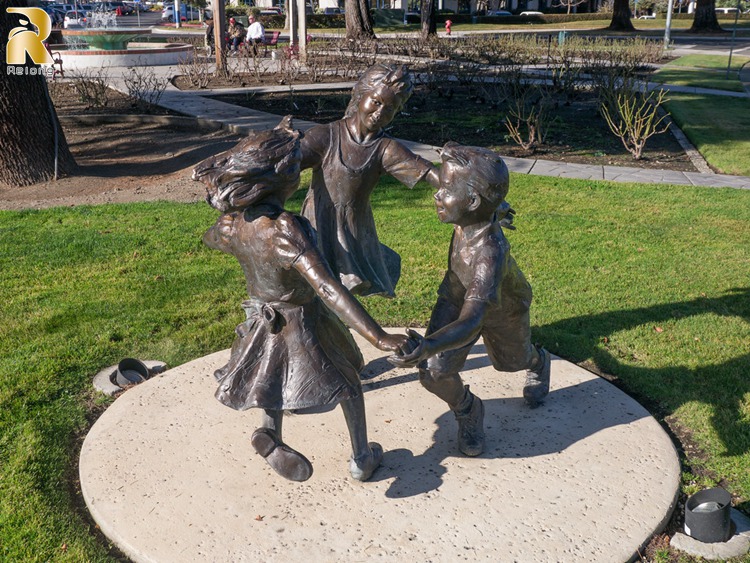 bronze boy and girl statue