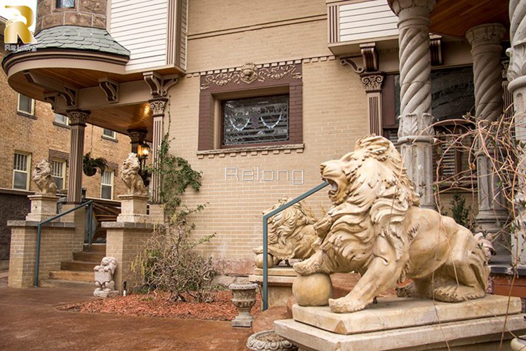 marble lion statue with a ball