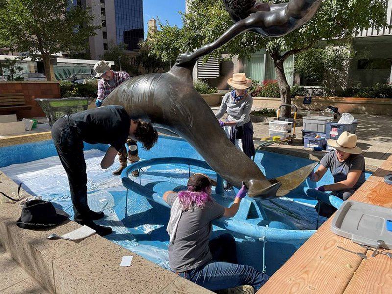 outdoor boy on a dolphin statue