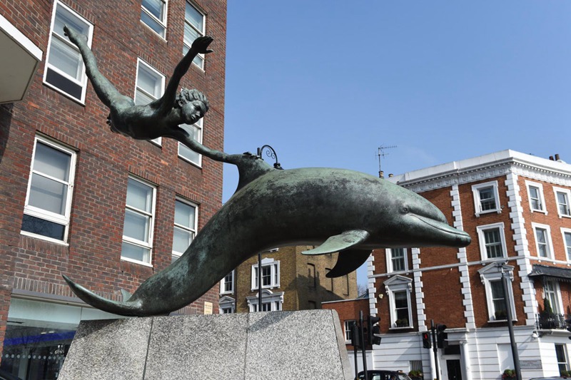 outdoor decorative boy with dolphin statue