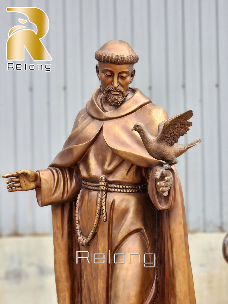 religious St. Francis statue with birds