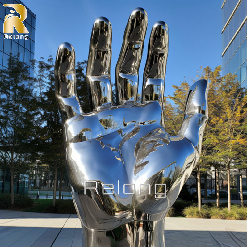 large stainless steel hand sculpture