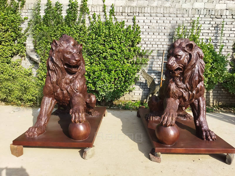 outdoor bronze lion statue with paw on ball (3)